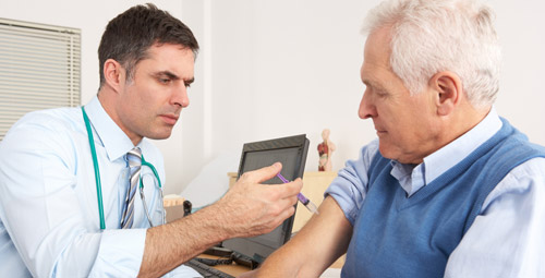 Doctor vaccinating an older male patient